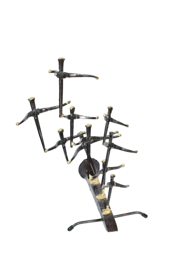 Freestanding metal sculpture of nine abstract gull figures made of steel cut nails, welded together and the wings tipped with bronze, with the group mounted on a railroad spike