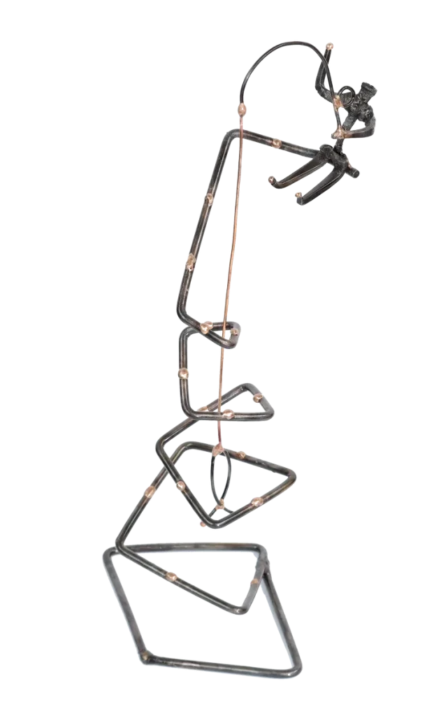 Freestanding abstract metal sculpture of a fisherman atop of and fishing from a spiraled steel tower with bronze dotted accents. The fisherman is made of steel cut nails and depicted waving with one hand, steel fishing pole in other hand with a copper fish on the end of a copper fishing line.