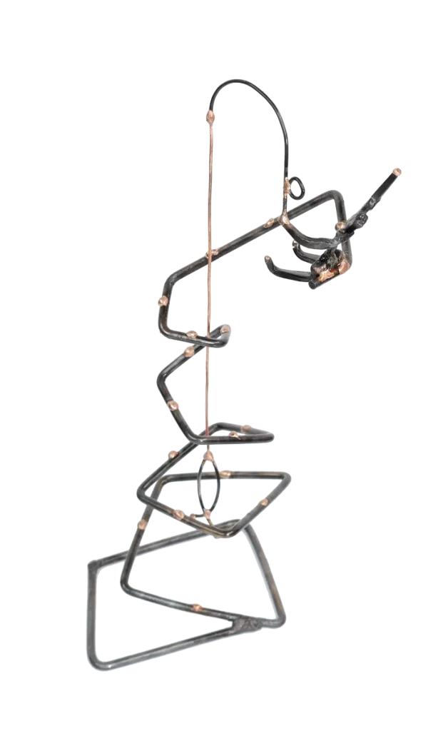 Freestanding abstract metal sculpture of a fisherman atop of and fishing from a spiraled steel tower with bronze dotted accents. The fisherman is made of steel cut nails and depicted waving with one hand, steel fishing pole in other hand with a copper fish on the end of a copper fishing line.