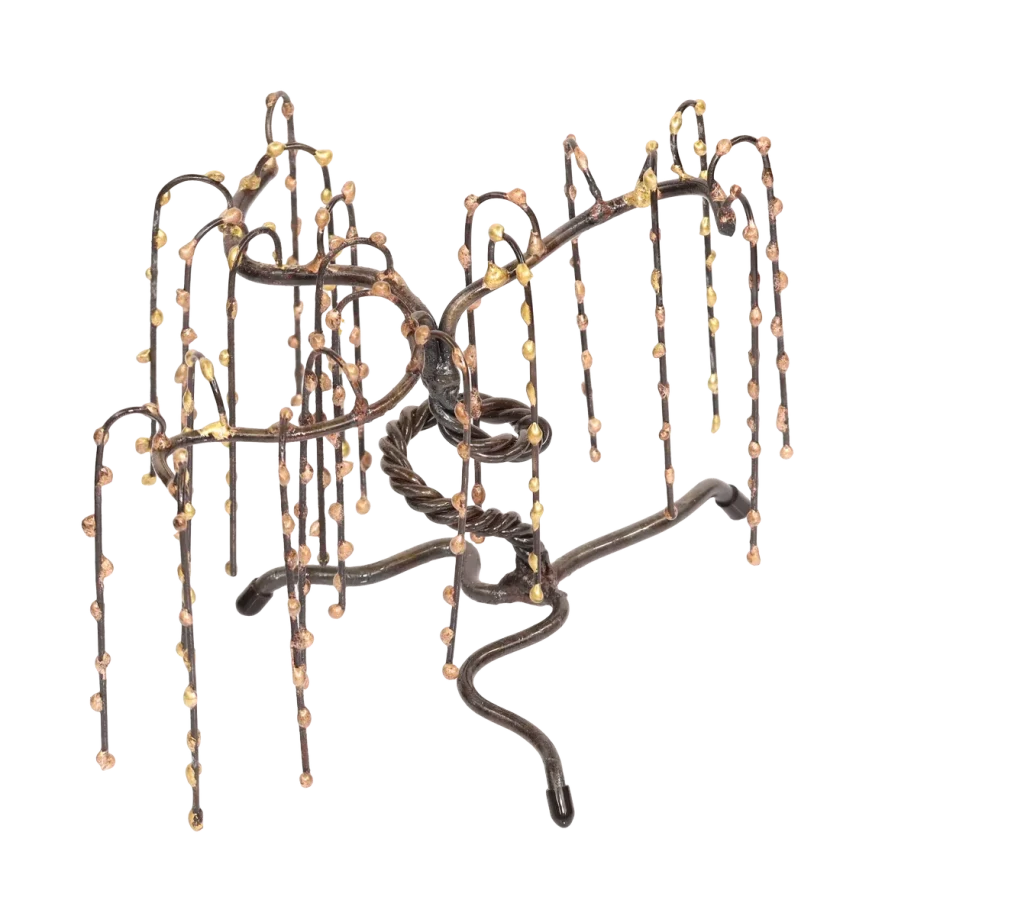 Freestanding metal sculpture of a weeping willow tree with a twisted steel trunk, and steel branches adorned with small, bronze spheres on the branches.