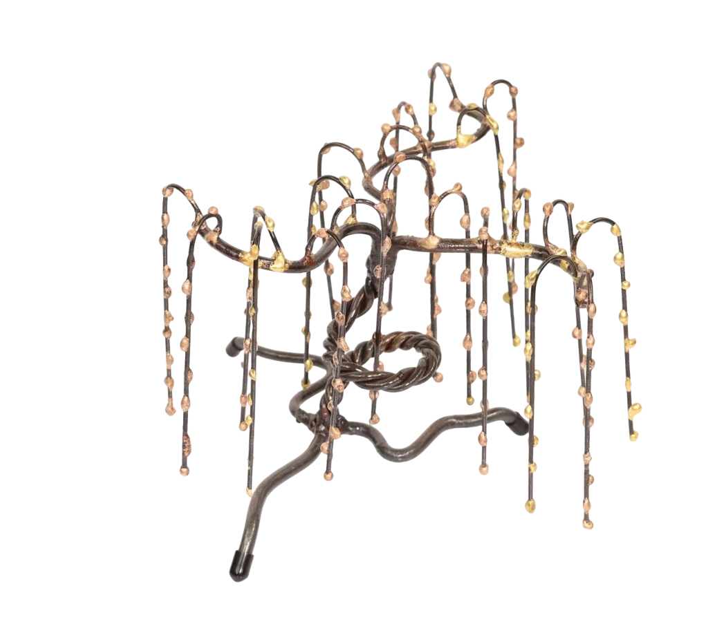 Freestanding metal sculpture of a weeping willow tree with a twisted steel trunk, and steel branches adorned with small, bronze spheres on the branches.