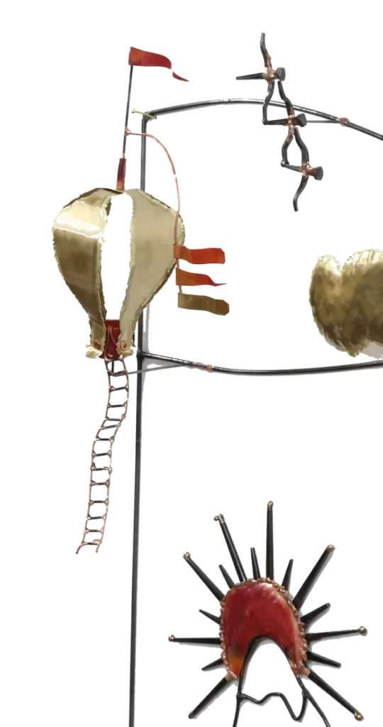Wall mounted metal art depicting three copper and brass hot air balloons with flags, floating above stylized brass clouds and snow-capped steel mountains, with a copper sun rising over the peaks.